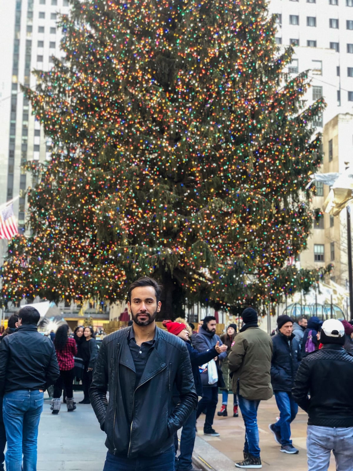 Alex next to NYC Christmas three at Rockefeller Center