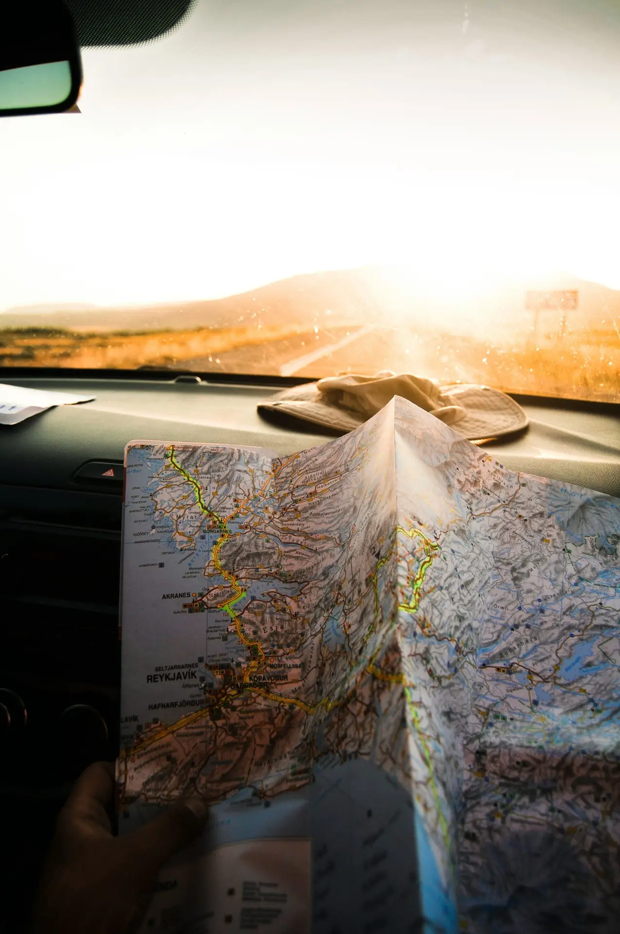 paper map on a travelers hand shot on the road in Iceland