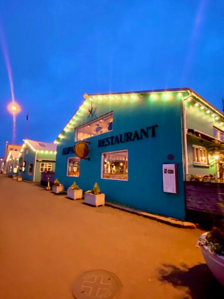Colorful restaurant buildings along Reykjavík’s old harbor in the evening