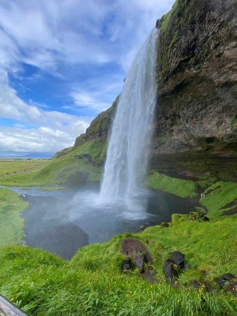 Seljalandsfoss waterfall pouring over a green cliff on Iceland’s south coast